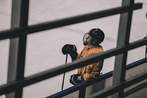 ice hockey man inside ice hockey court fence